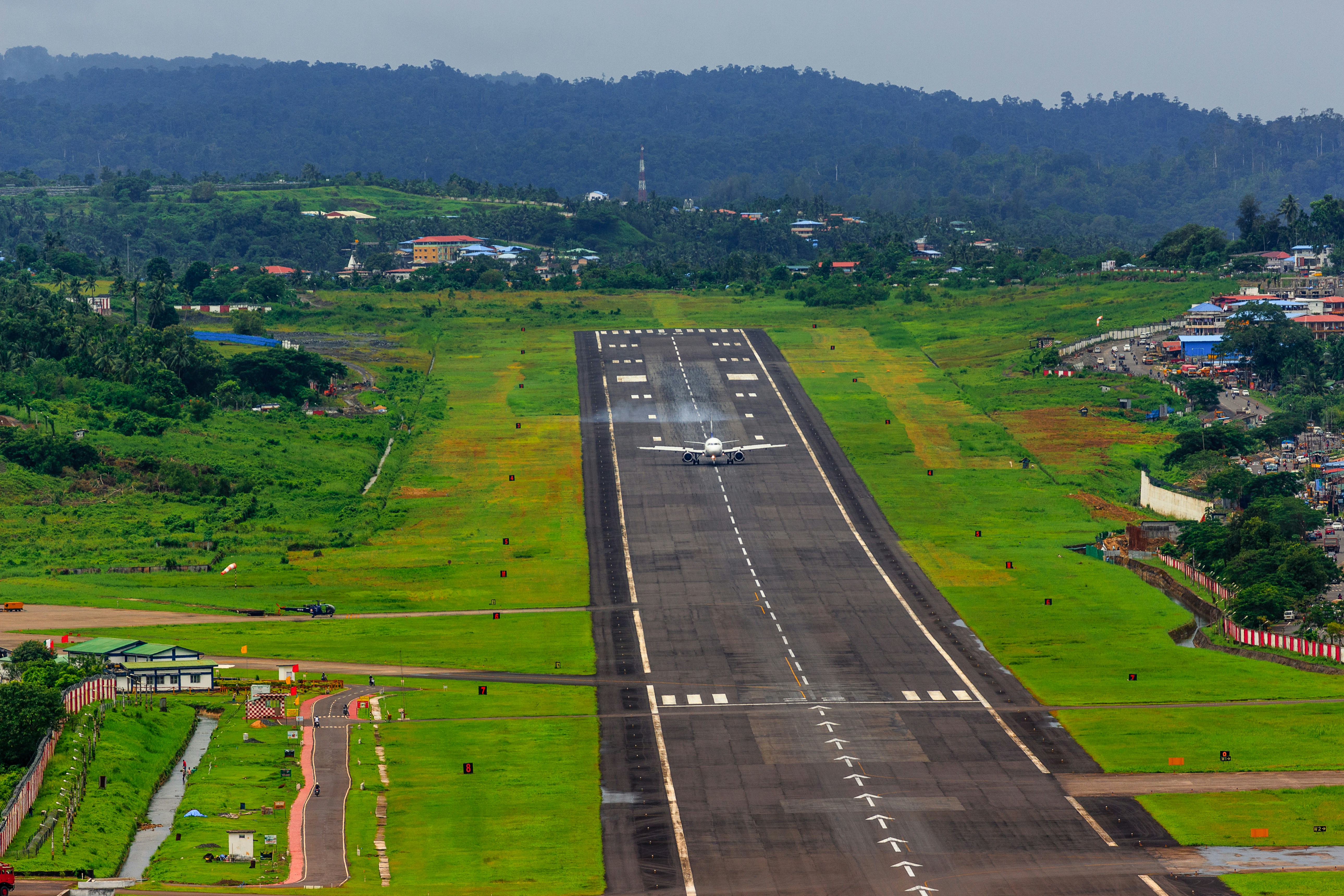 Aircraft landing amid green hills near Sri Vijaya Puram Andaman